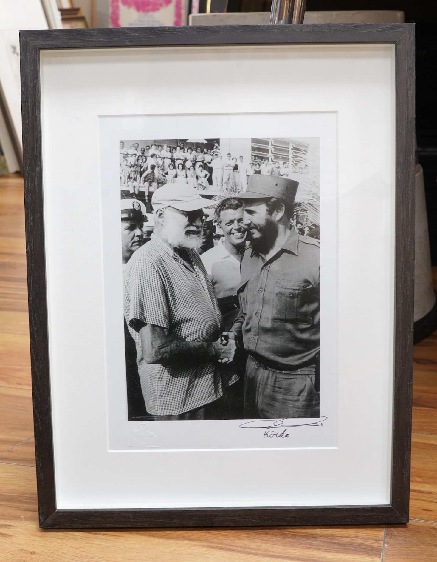 Alberto Korda (1928-2001), ‘Fidel Castro and Ernest Hemingway shaking hands’, stamped, signed in ink to the margin, with ADK blind stamp, gelatin silver print, 28 x 19cm